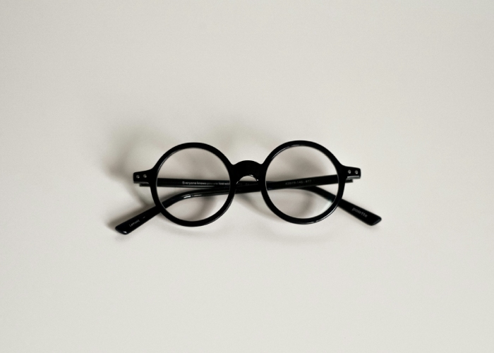 Gafas redondas negras sobre fondo claro, accesorio de estilo minimalista.